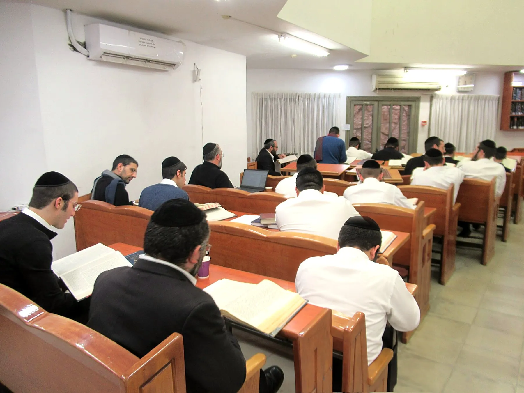 Yungeleit learning at rows of wooden shtenders at Nesivos Chaim, Beitar Illit