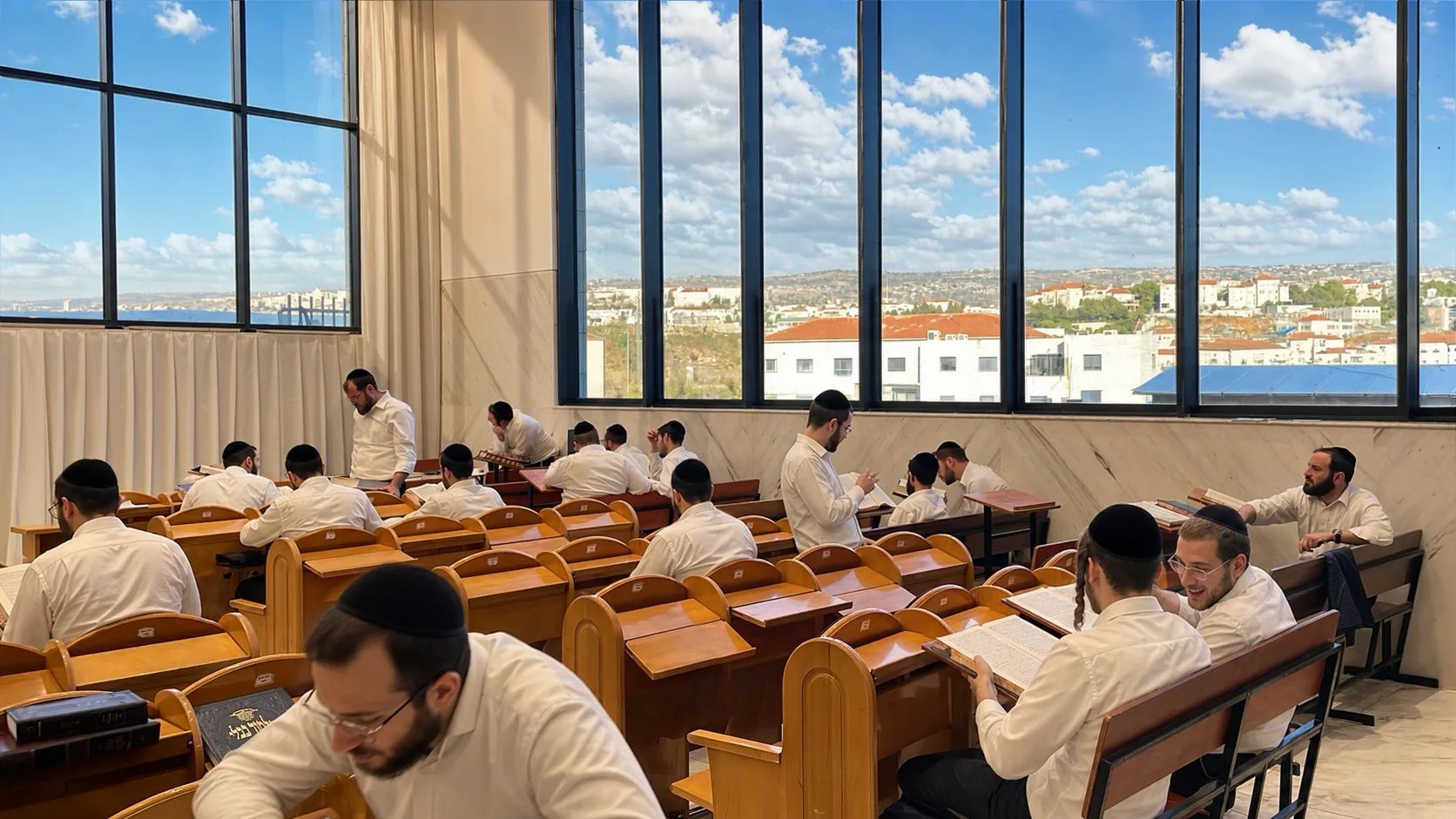 The same beis medrash in full morning light, every seat filled with avreichim learning